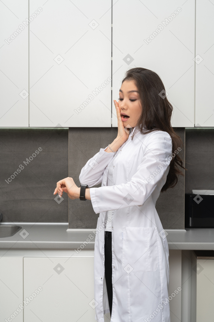 Surprised doctor checking the time