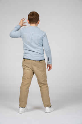 Back view of a boy showing small size of something