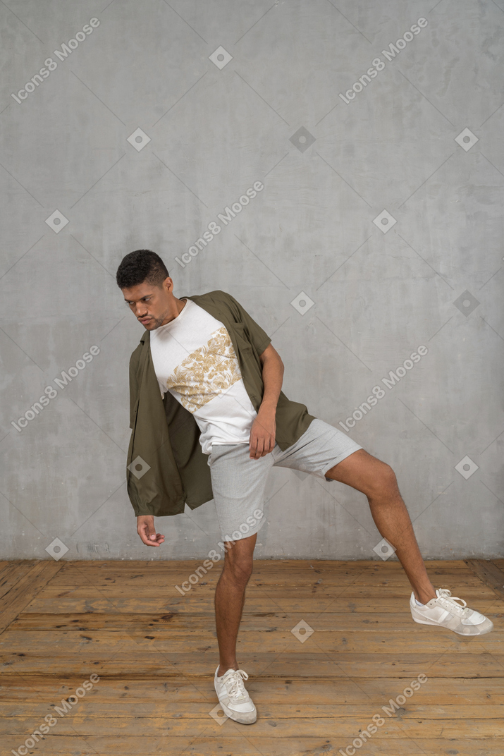 Man leaning backwards with his foot raised