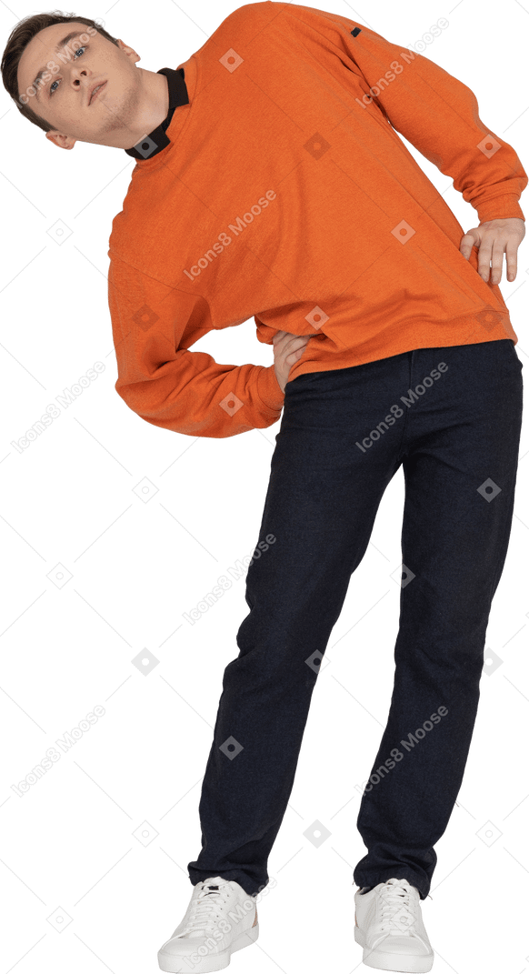 Young man in orange sweatshirt posing