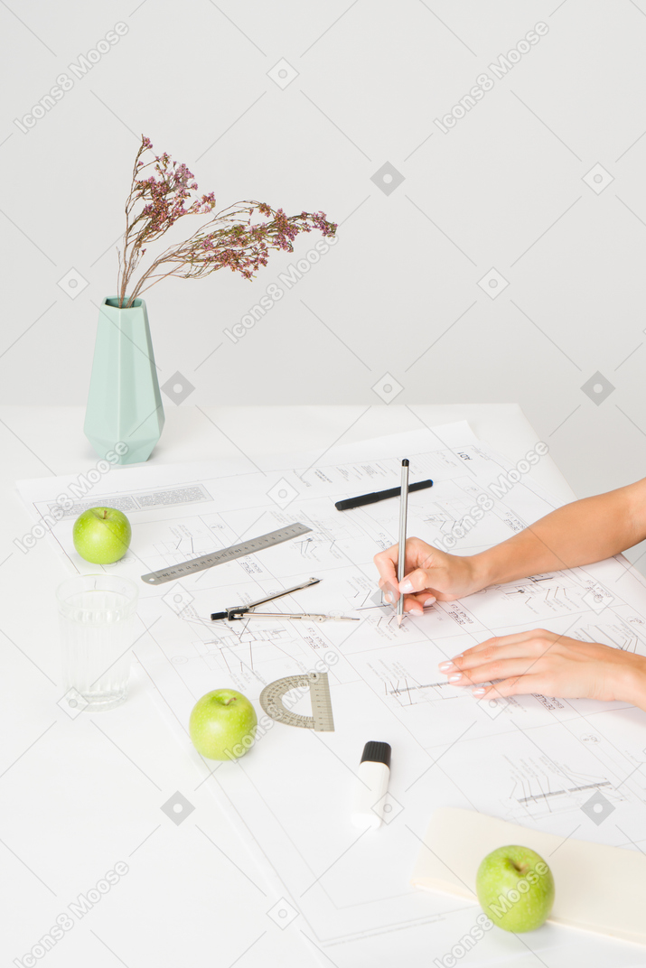 Architect hands working on blueprint