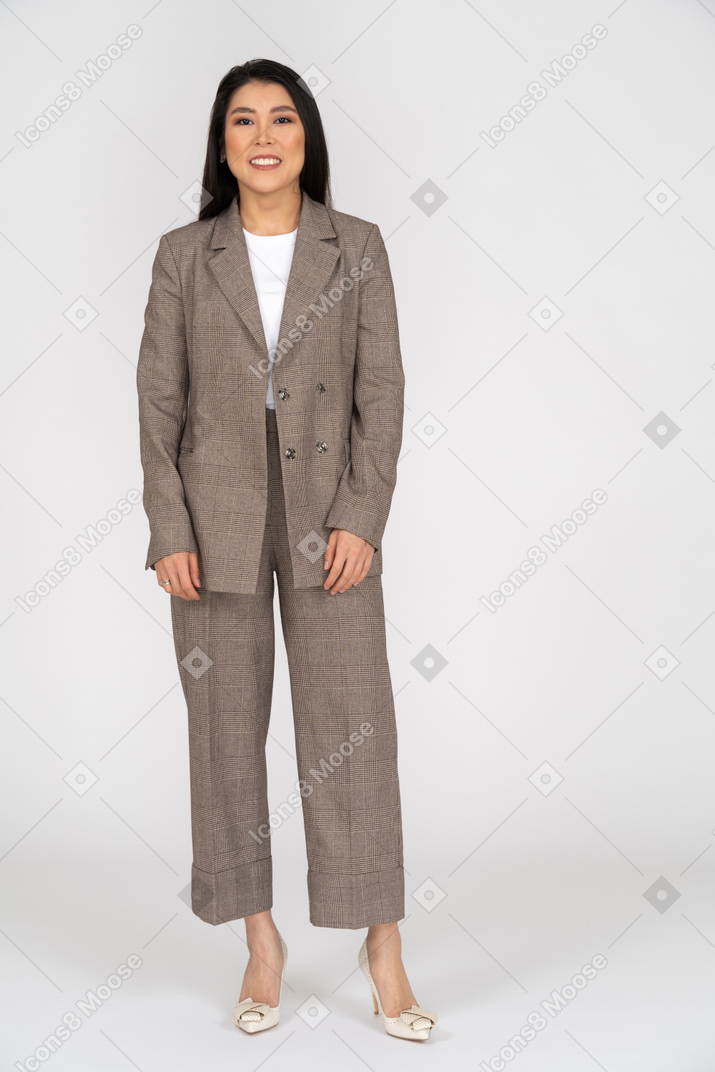 Front view of a smiling young lady in brown business suit