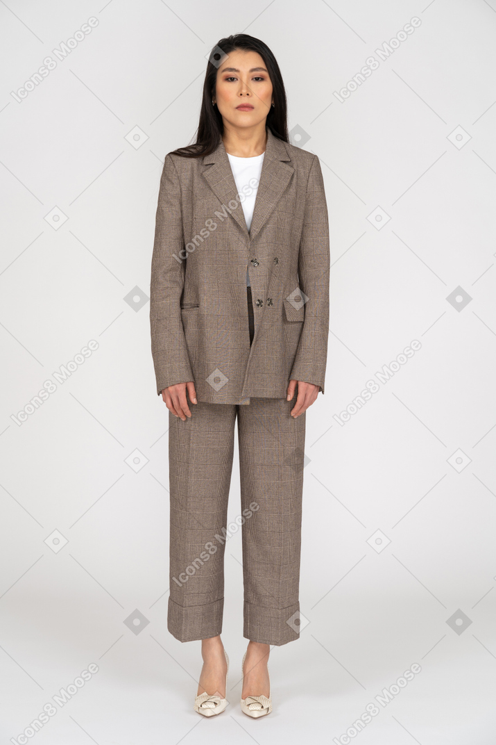 Front view of a young lady in brown business suit looking straight down
