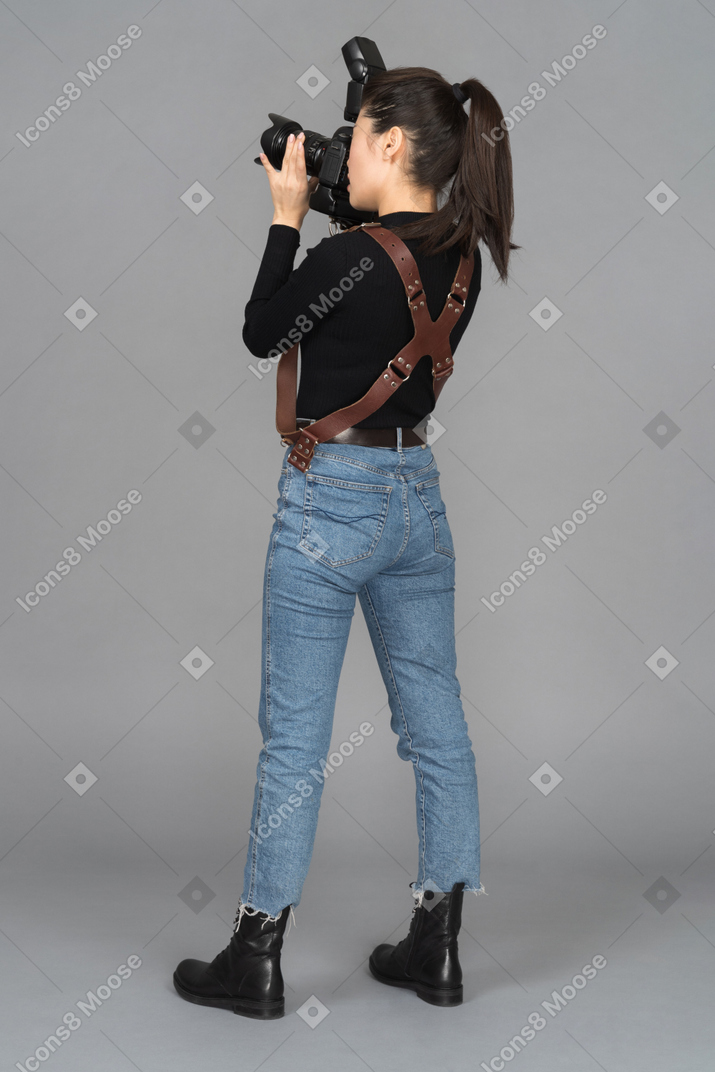 Female photographer taking pictures while standing