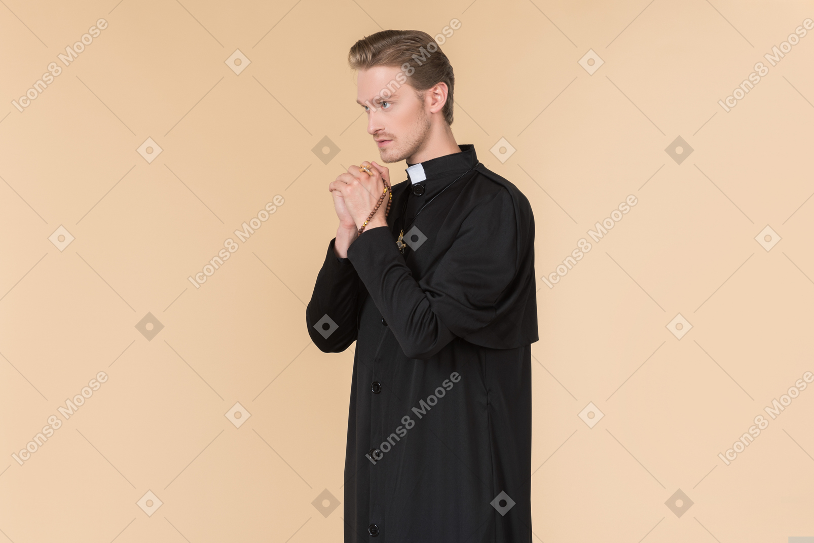 Catholic priest praying with eyes closed using prayer beads