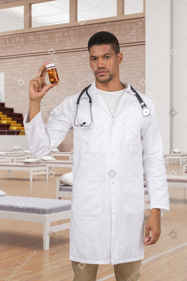 A man in a white lab coat holding a jar of pills