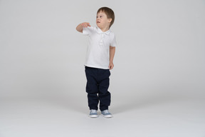 Front view of little boy pointing at camera