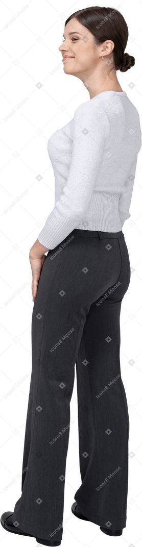 Three-quarter back view of a pleased young woman in office clothing