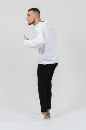 Back view of a man in casual clothes gesturing