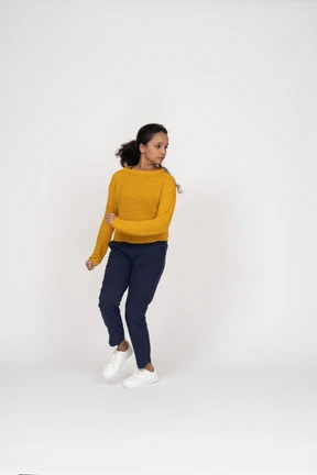 Front view of a girl in casual clothes running forward