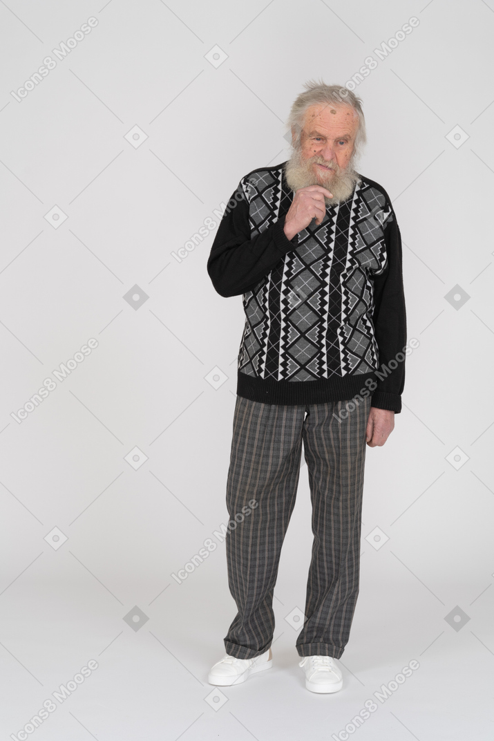Front view of an old man holding his beard