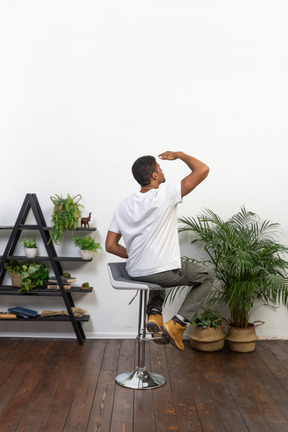 Good looking young man sitting on a chair