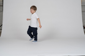 Cheerful little boy running around