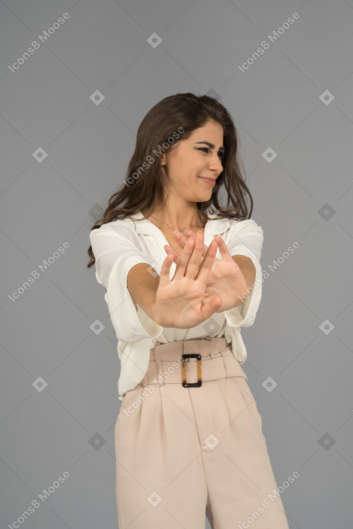 Unsatisfied young woman rejecting a proposal with both hands