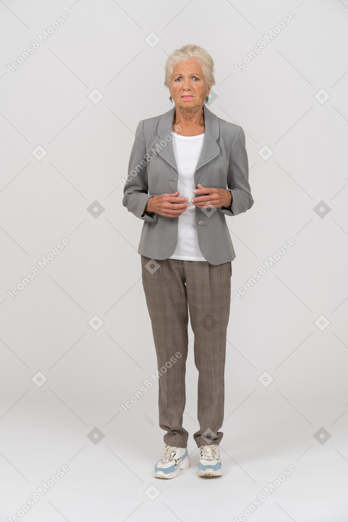 Upset old lady in suit looking at camera