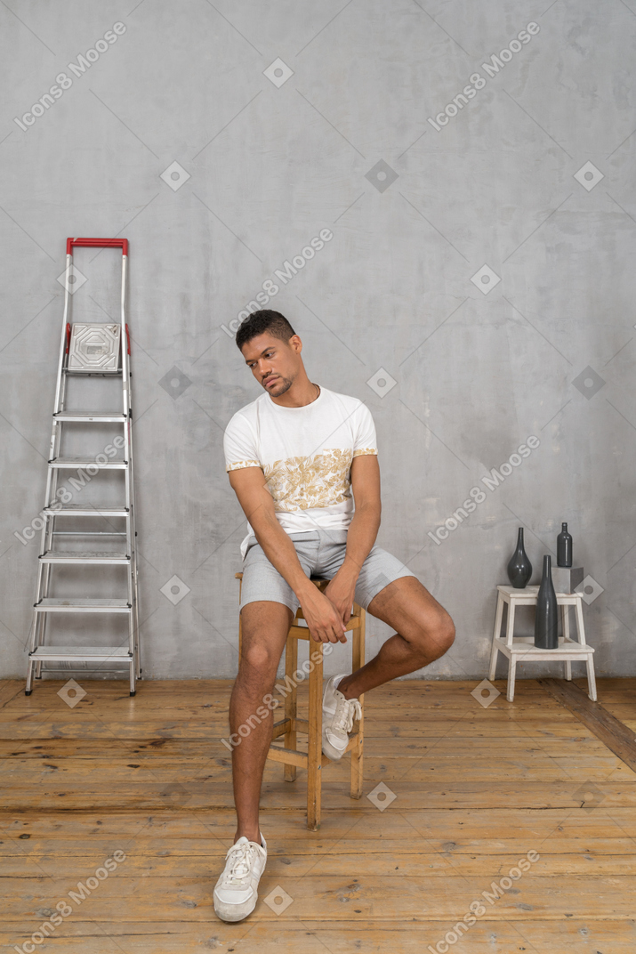 Hombre con ropa informal sentado y mirando a un lado