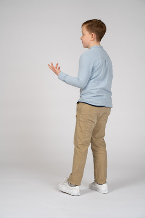 Side view of a boy explaining something