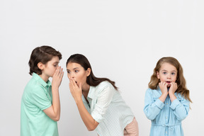 Attractive boy sharing a secret with his mother