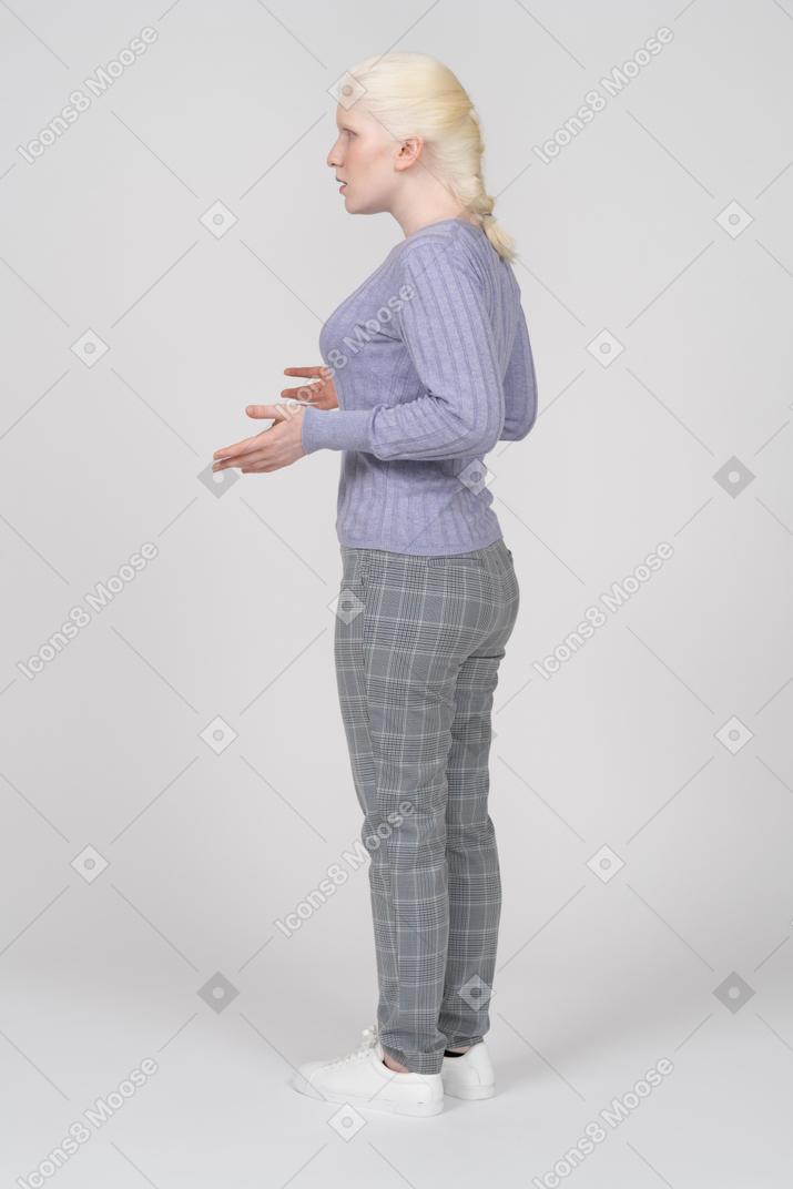 Side view of young woman explaining and gesturing