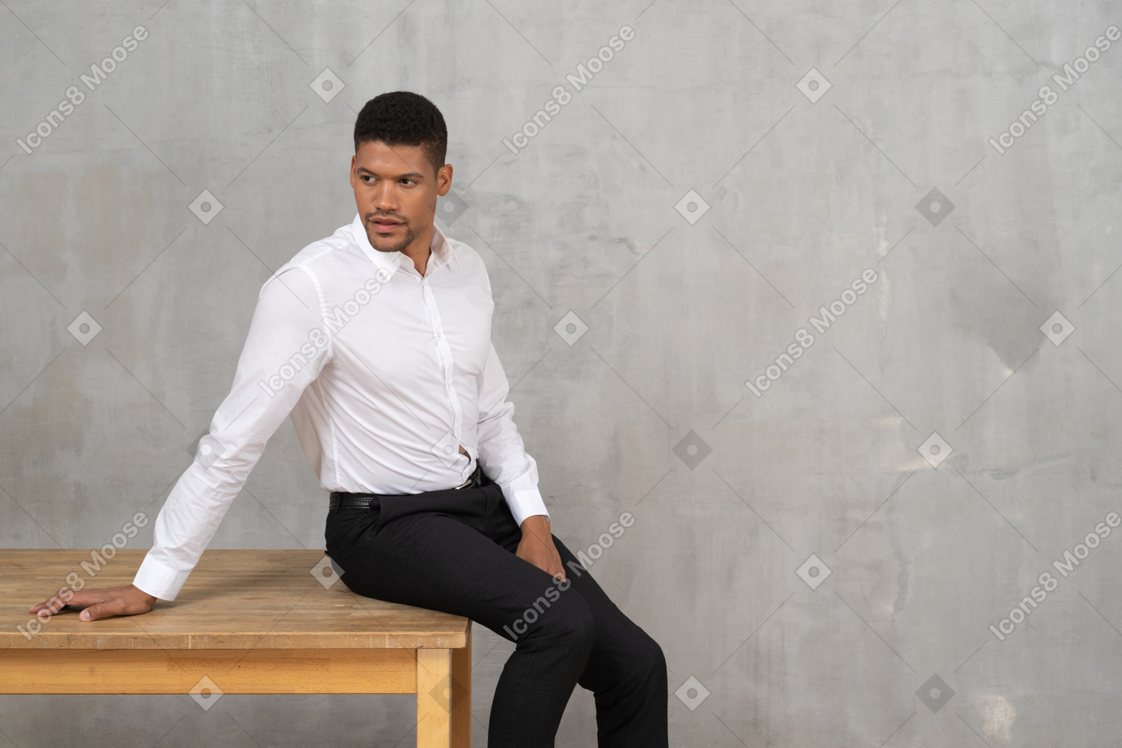 Man in office clothes sitting on a table