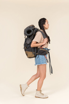 Young asian female hiker standing in profile