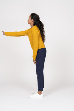 Side view of a girl in casual clothes showing direction