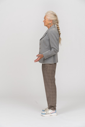 Old lady in suit standing in profile