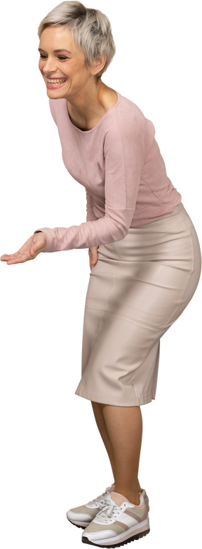 Front view of a happy woman in casual clothes making welcoming gesture