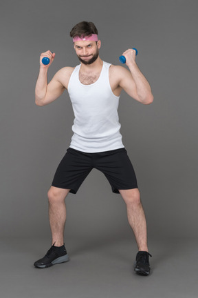 Young man working out with dumbbells