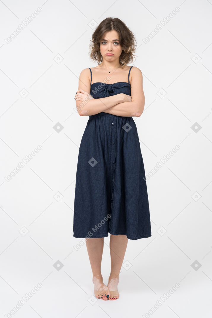 Disappointed young woman keeping arms crossed