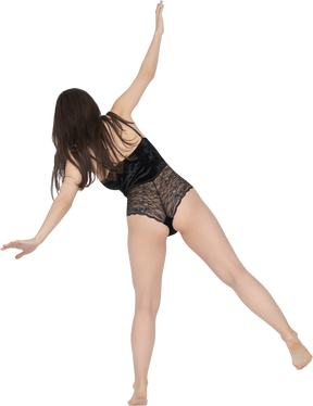 Unrecognizable brunette female making side bends with outstretched arms