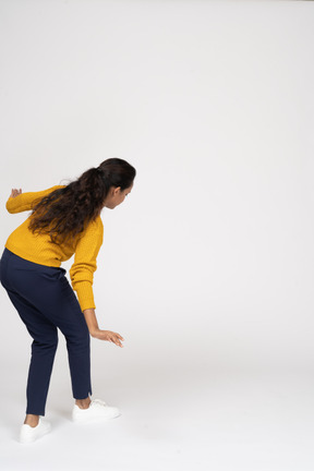 Rear view of a girl in casual clothes walking