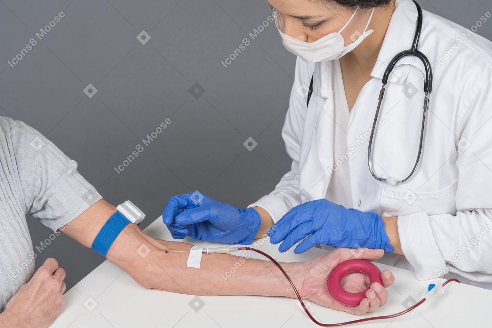 Female doctor taking blood from patient's vein