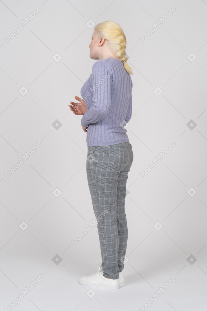 Rear view of speaking young woman