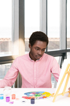 A couple of people sitting at a table with a painting