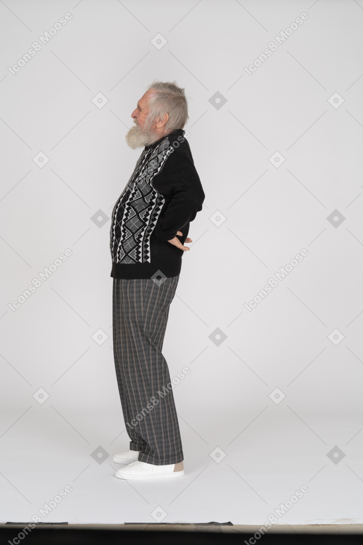Side view of old man groaning with pains in back