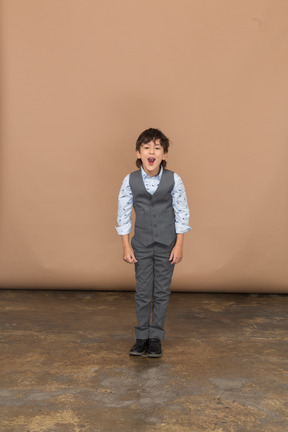 Front view of a cute boy in suit looking at camera