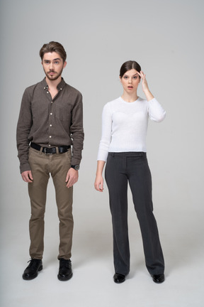 Full-length of a young man in office clothing and young woman touching head