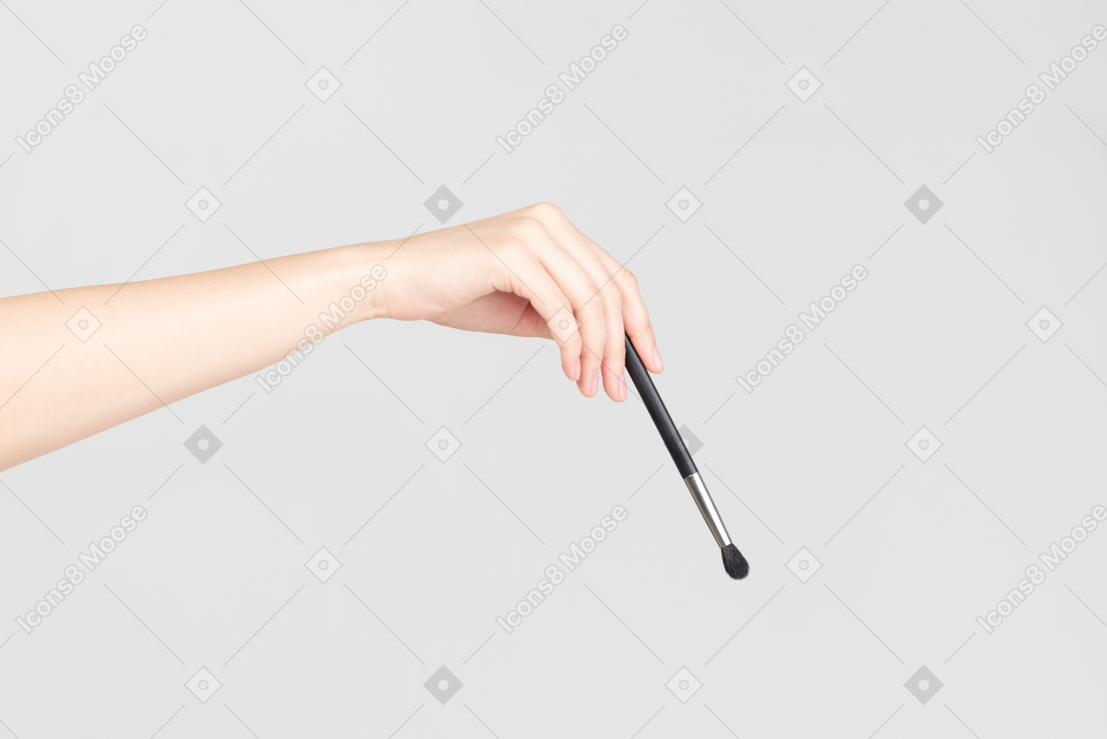 Female hand holding brush