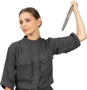 Front view of a young woman in a jumpsuit holding glass plate