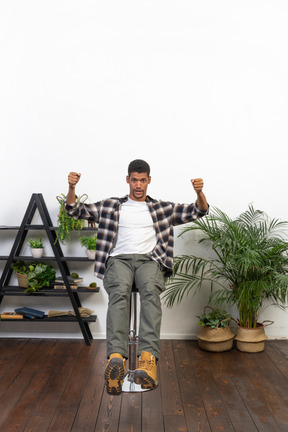 Good looking young man sitting on a chair