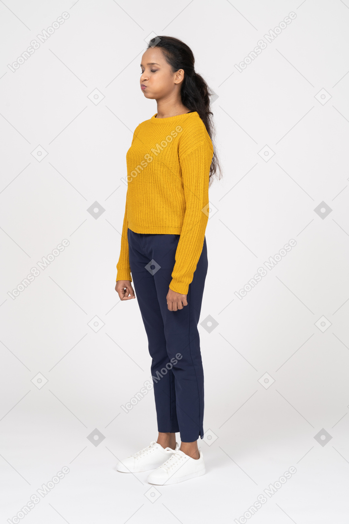 Side view of a beautiful girl in casual clothes making faces