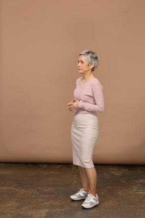 Upset woman in casual clothes standing in profile